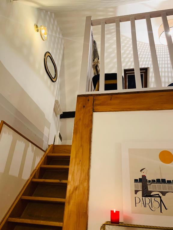 a staircase in a house with a dog sitting on the stairs at La maison de Nina in Sens