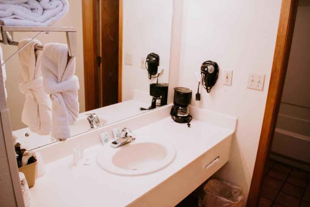 a bathroom with a white sink and a mirror at Days Inn By Wyndham Pigeon Forge South in Pigeon Forge