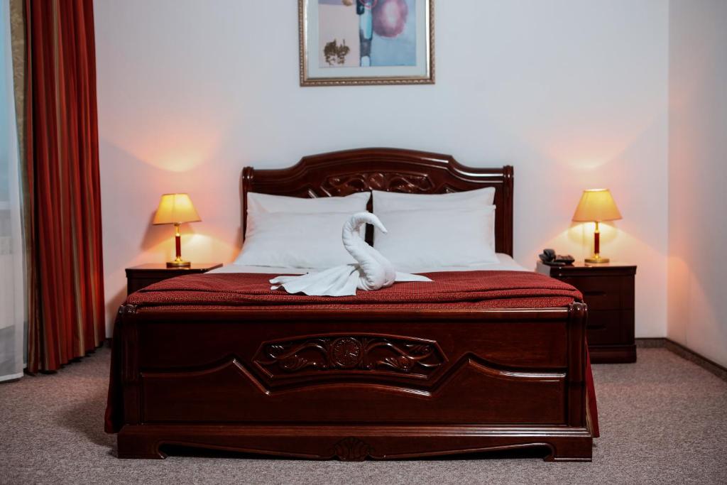 מיטה או מיטות בחדר ב-Siberia Hotel