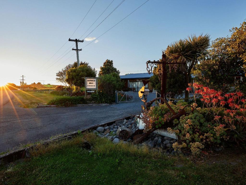 a street with flowers on the side of a road at Barnacle Bills in Kaikoura