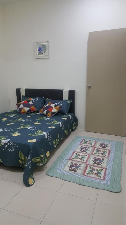 a living room with a bed and a rug at Homestay AlFaruqi Gambang 1 in Gambang