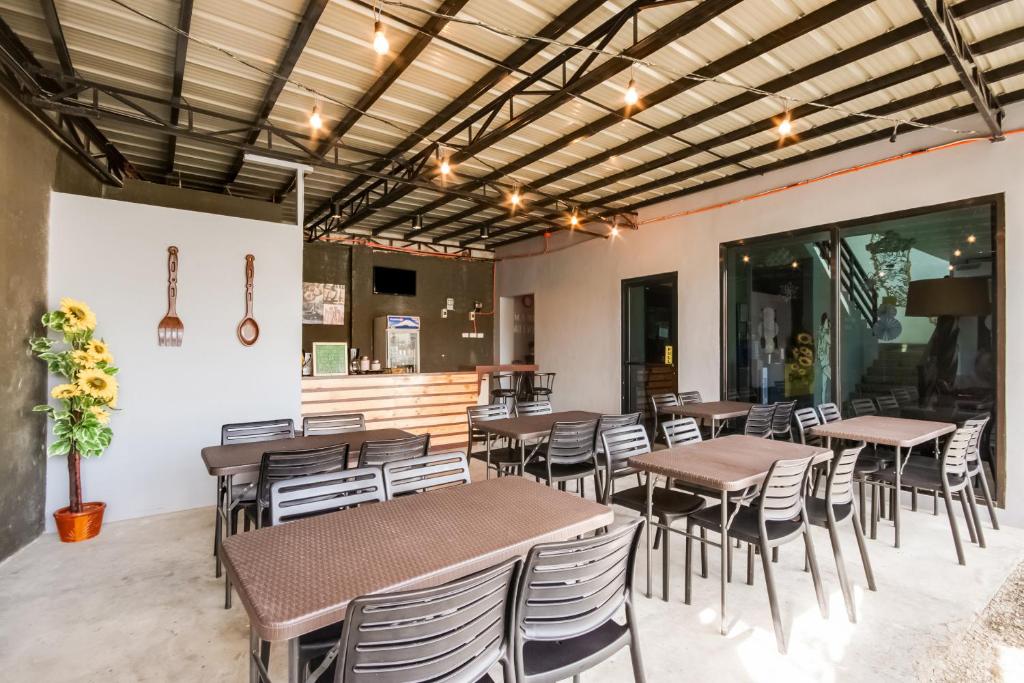 a restaurant with tables and chairs in a room at The Pocket Hotel in Mactan