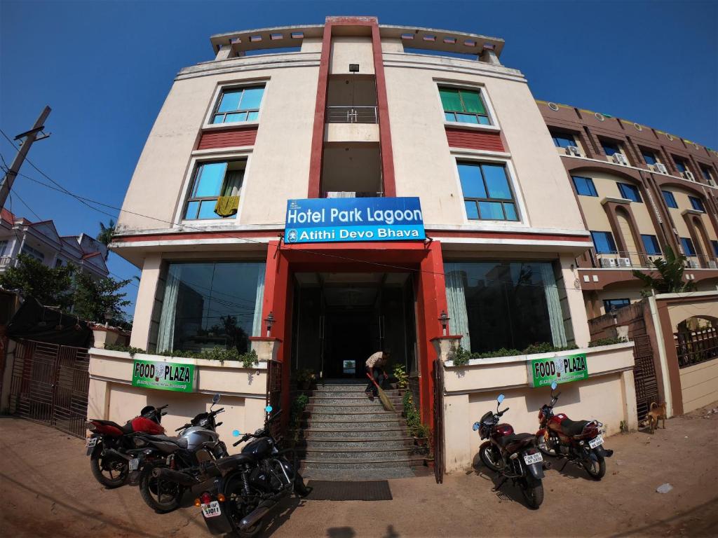 a building with three motorcycles parked in front of it at HOTEL PARK LAGOON in Puri
