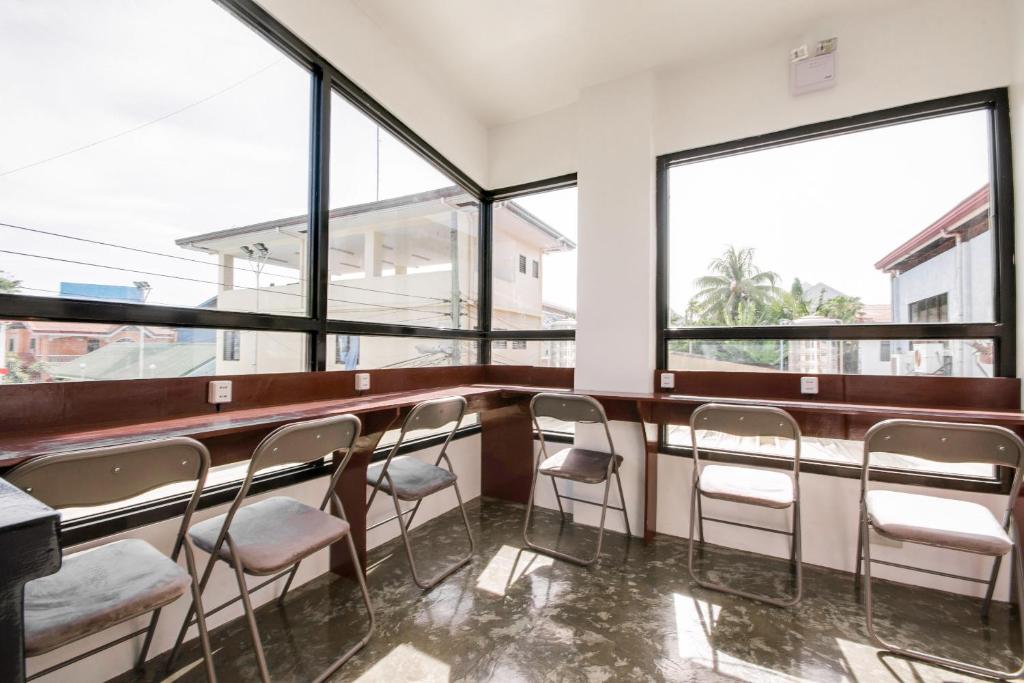a row of chairs in a waiting room with windows at The Pocket Hotel in Mactan