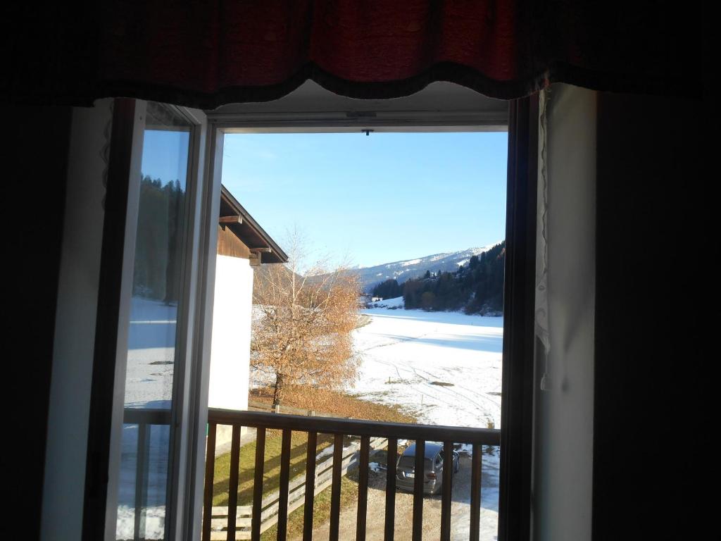 a window with a view of a snow covered field at CASA CAMPAGNA in Cavalese