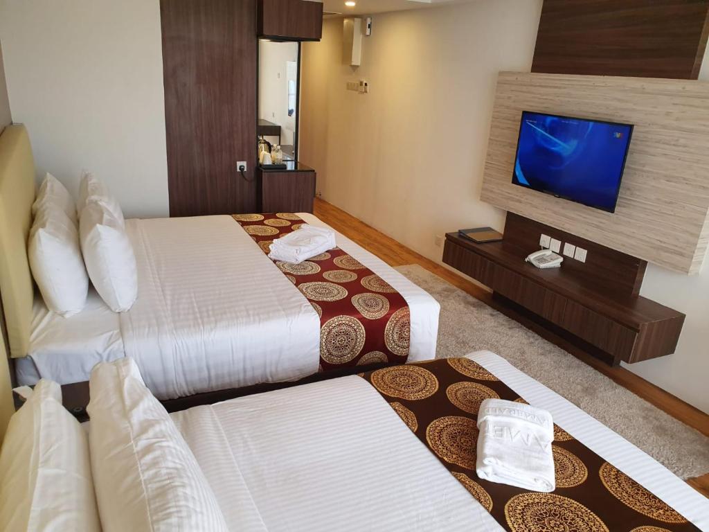 Postel nebo postele na pokoji v ubytování AMERALD RESORT HOTEL DESARU