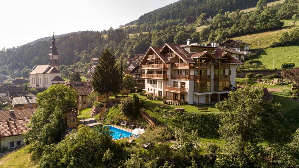 ein großes Haus auf einem Hügel mit Pool in der Unterkunft Villa Messner in Villnöss