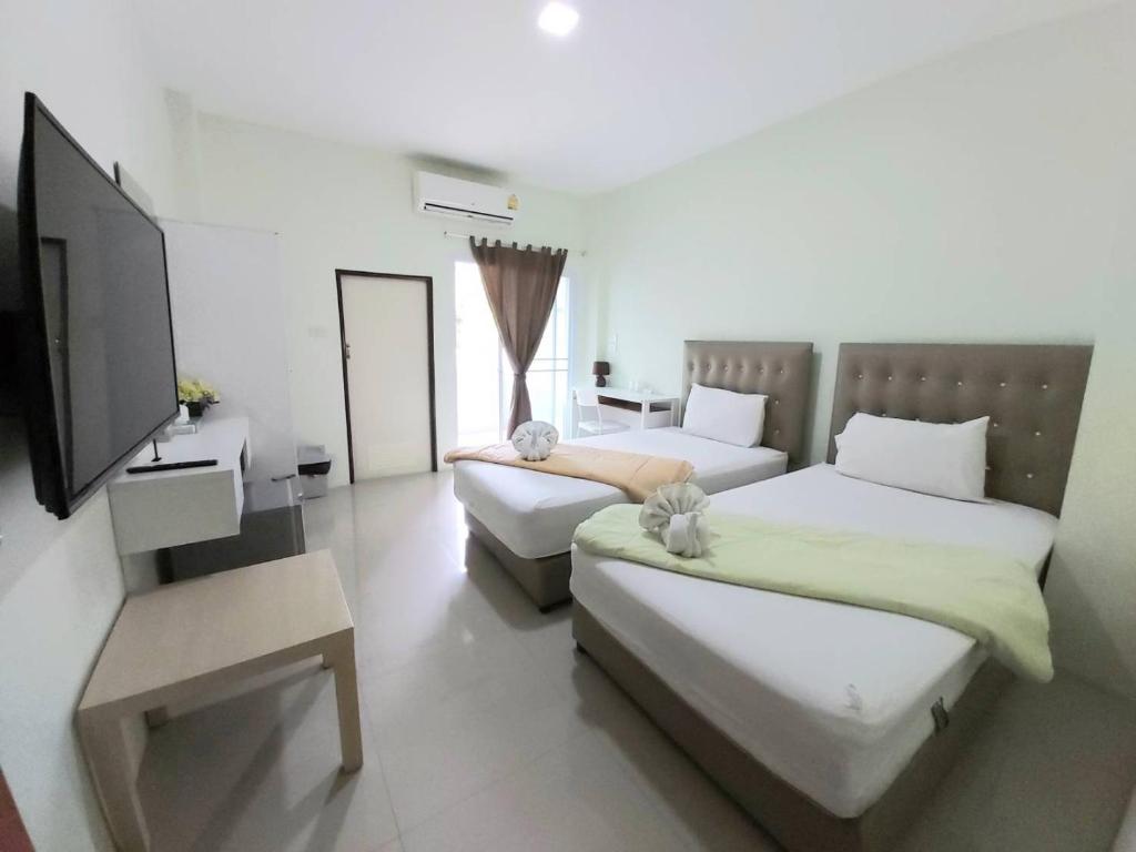 Postel nebo postele na pokoji v ubytování Papangkorn House