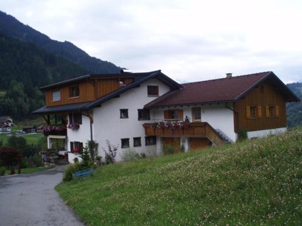 a house on top of a hill with a house at Loretz Luzia in Silbertal