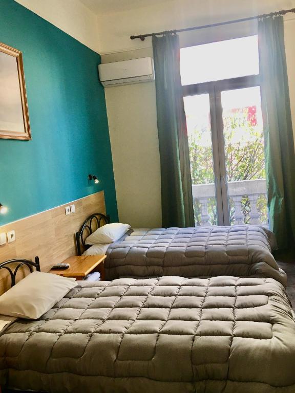 Postel nebo postele na pokoji v ubytování Hotel Kastoria