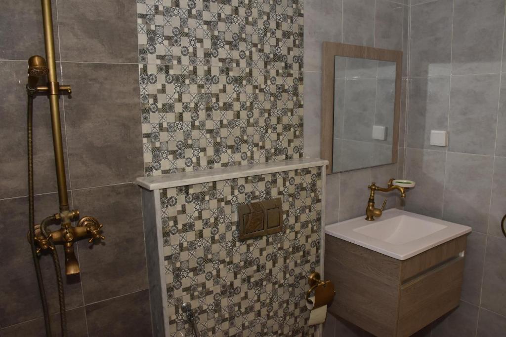 a bathroom with a sink and a mirror at Arabesque Style - 2 appartements in Kelibia
