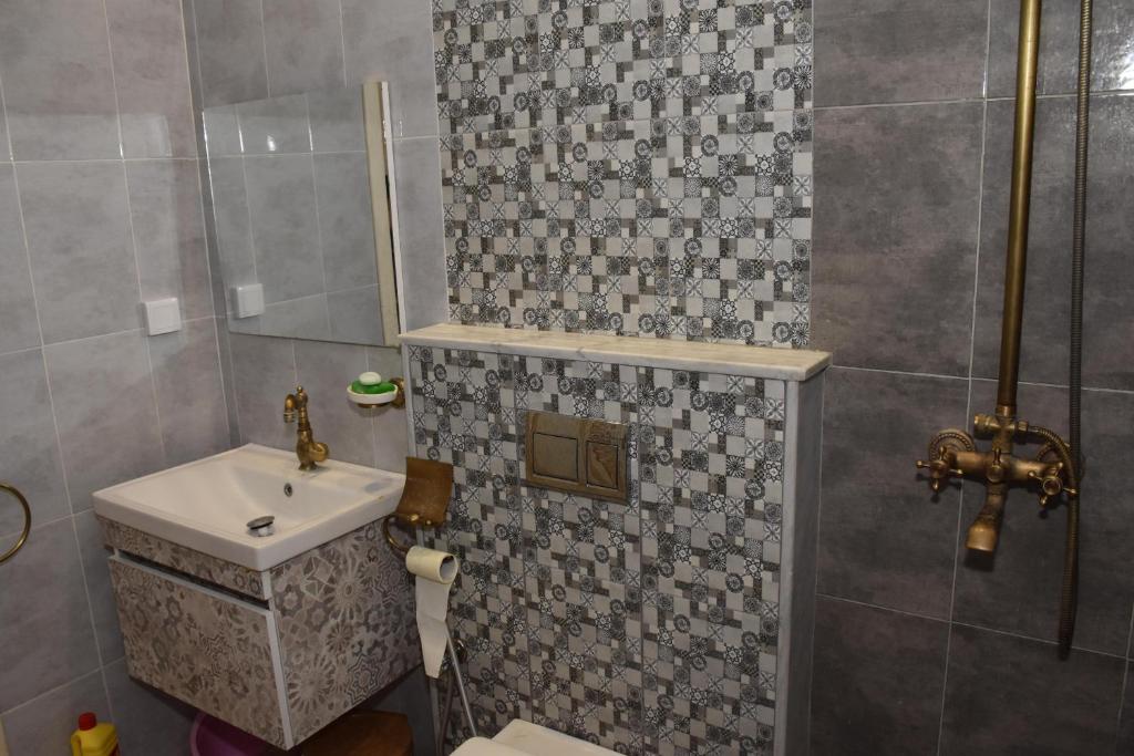 a bathroom with a toilet and a sink and a shower at Arabesque Style - 2 appartements in Kelibia