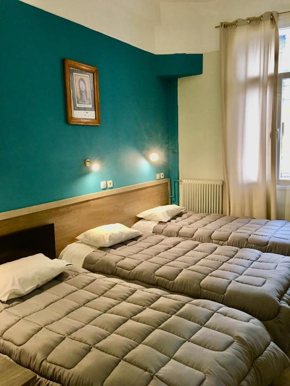 Postel nebo postele na pokoji v ubytování Hotel Kastoria