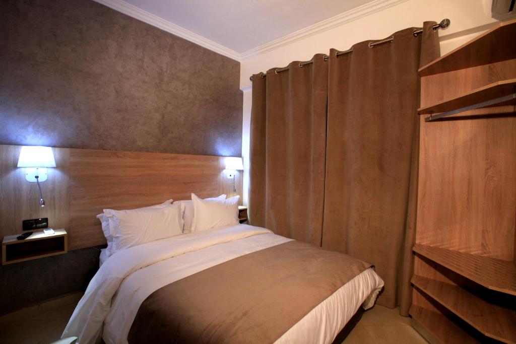Postel nebo postele na pokoji v ubytování Hotel Ichbilia فندق اشبيلية