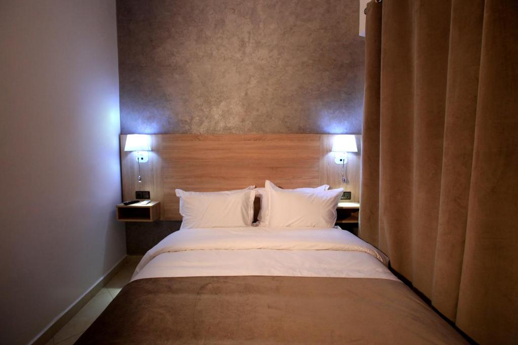 Postel nebo postele na pokoji v ubytování Hotel Ichbilia فندق اشبيلية