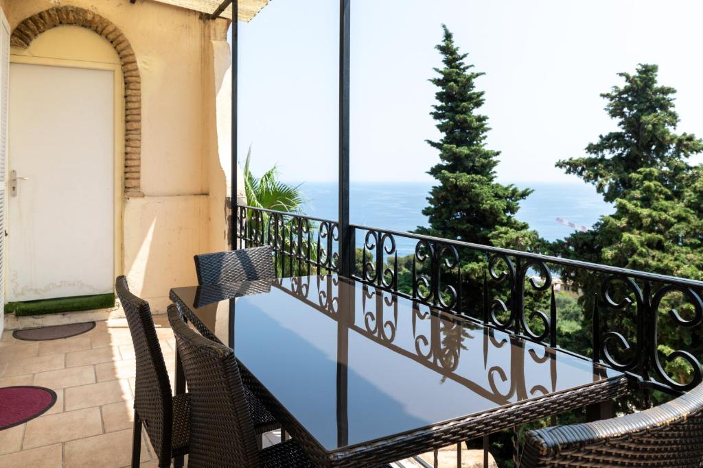 a balcony with a view of the ocean at Villa Azur Cap d'Ail in Cap d'Ail