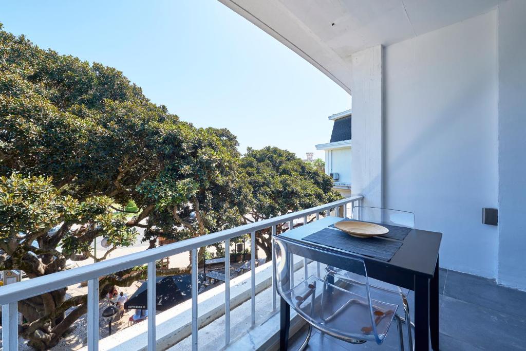 a table on a balcony with a view of the beach at Estoril BeachFront Balcony apartment in Estoril