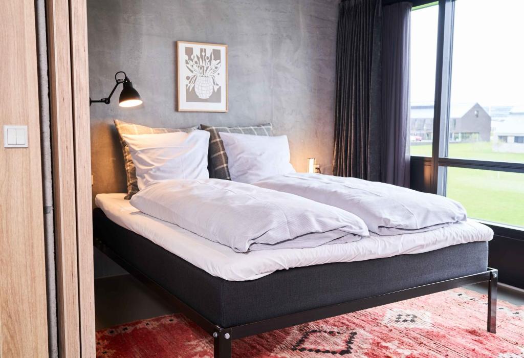Un pat sau paturi într-o cameră la Hotel GUESTapart
