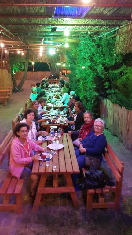 a group of people sitting at a long table at Grand Yayla Hotel in Çeşme
