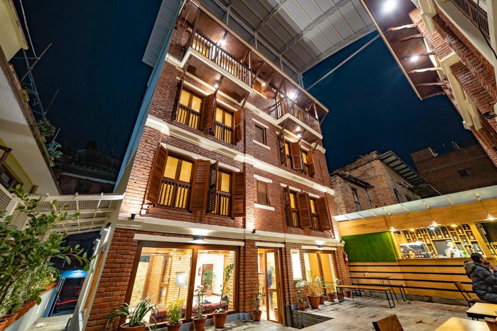 a tall brick building with windows and a ceiling at Traditional Stay - A Boutique Hotel in Pātan