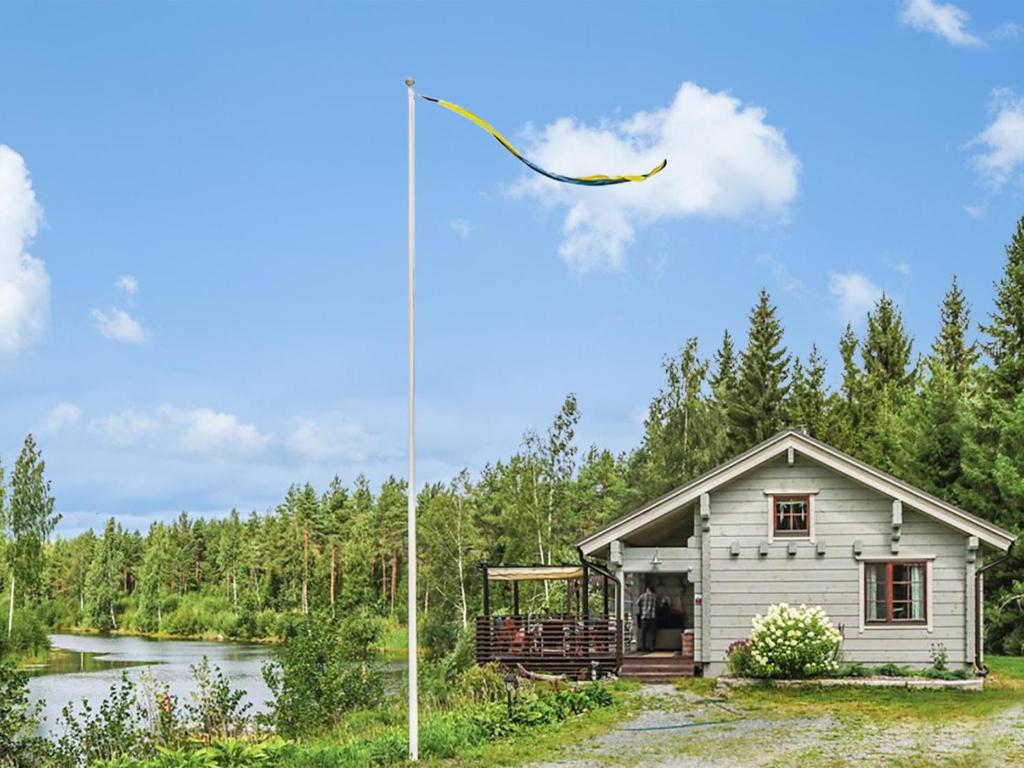 a kite flying in the sky over a house at Holiday Home Ruuhikari by Interhome in Ulvila