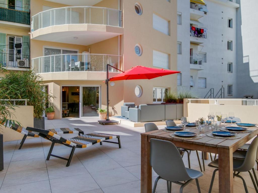 a patio with a table and chairs and an umbrella at Apartment Palazzo Ribotti by Interhome in Nice