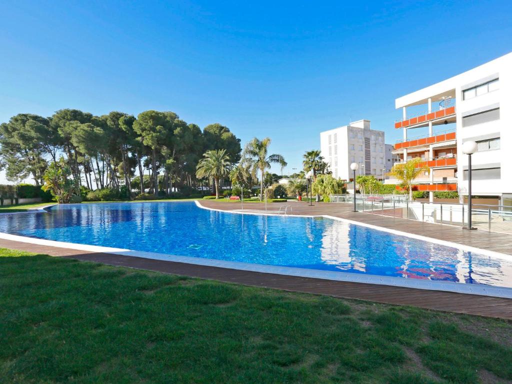 a swimming pool in a park next to a building at Holiday Home Sol Cambrils Park-6 by Interhome in Cambrils