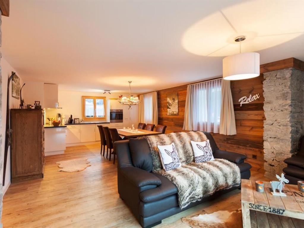 a living room with a couch and a table at Apartment Apartment Bristolino by Interhome in Saas-Fee