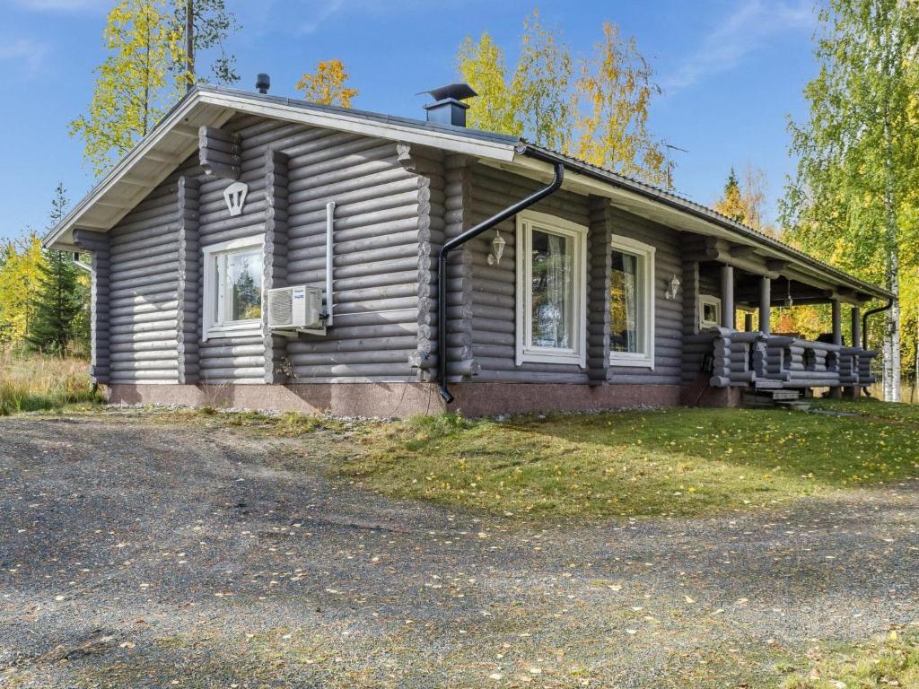 ein kleines Holzhaus mit einer Veranda auf einer Straße in der Unterkunft Holiday Home Markenniemi by Interhome in Ahveninen