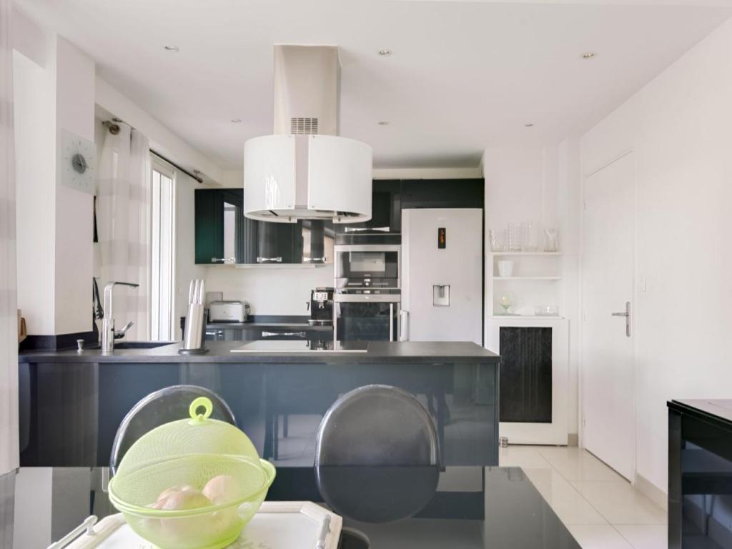 a kitchen with a green bowl on a table at Apartment Les Pins D&#39;Alep by Interhome in Le Cannet