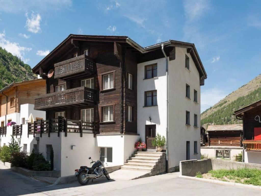 a motorcycle parked in front of a building at Apartment Zur Post by Interhome in Saas-Almagell