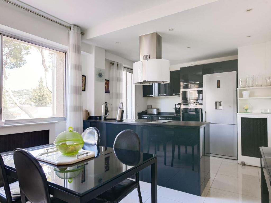 a kitchen with a dining table with a green bowl on it at Apartment Les Pins D&#39;Alep by Interhome in Le Cannet