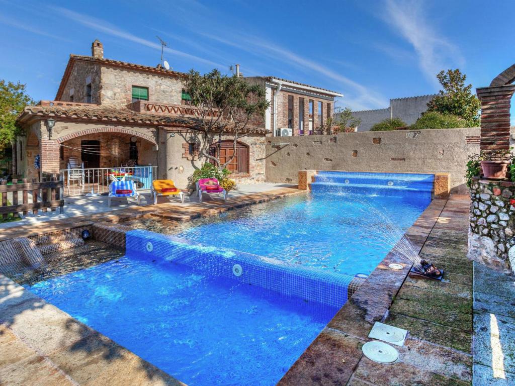 a swimming pool in front of a house at Holiday Home Can Funei by Interhome in Calonge