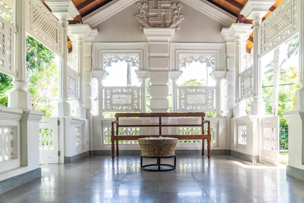 a room with a bench in the middle of a building at Kiri Palu in Ahangama