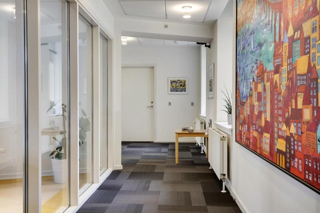 a hallway with a large painting on the wall at Hotel Garni in Svendborg