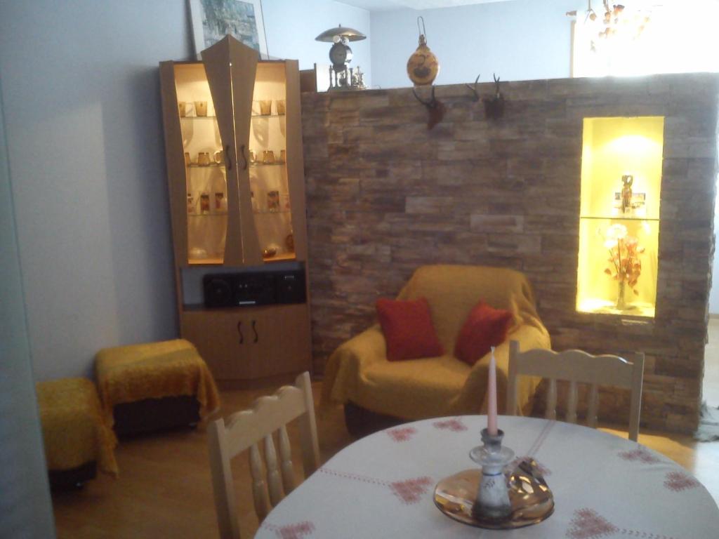 a dining room with a table and a chair at Rila Apartment in Samokov