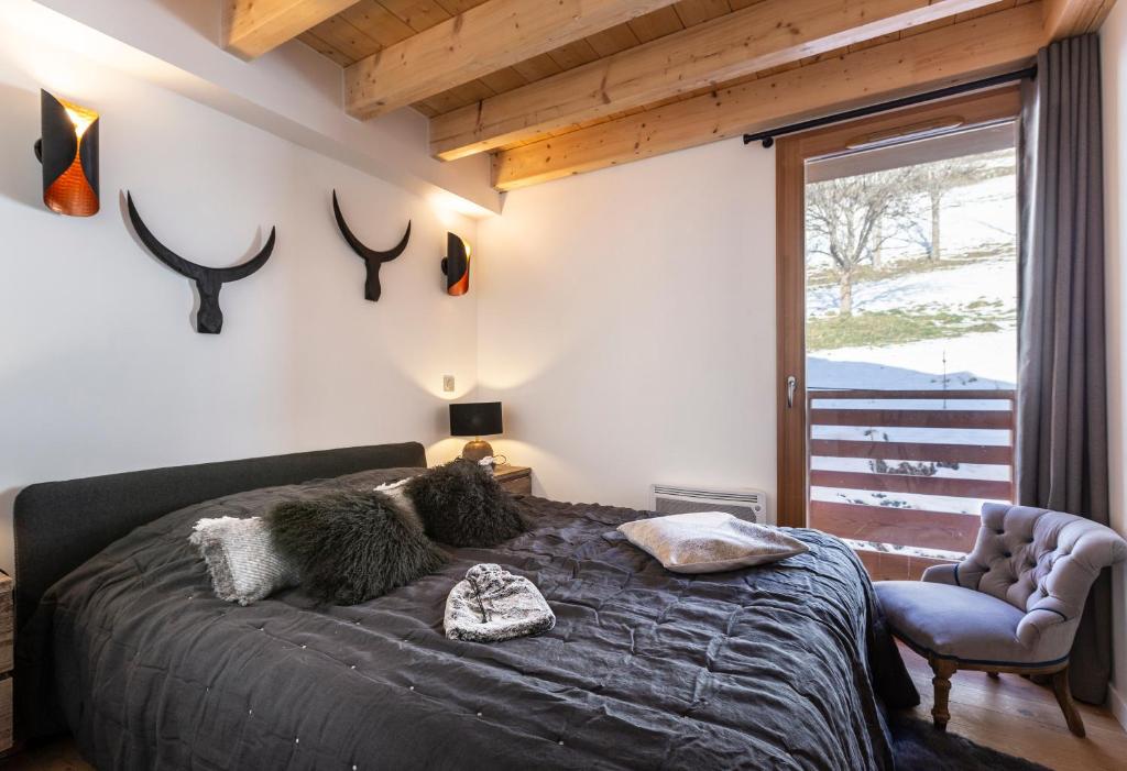 a bedroom with a bed with antlers on the wall at TERRESENS - Les Améthystes in Vaujany