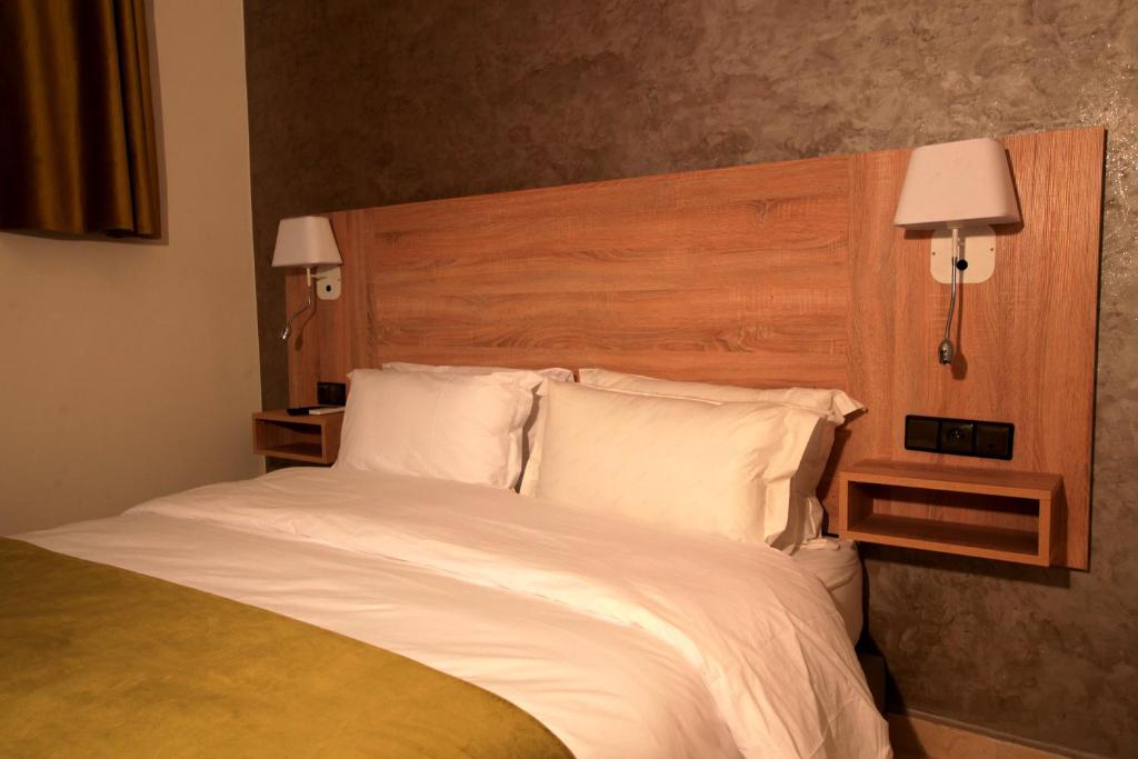 Postel nebo postele na pokoji v ubytování Hotel Ichbilia فندق اشبيلية