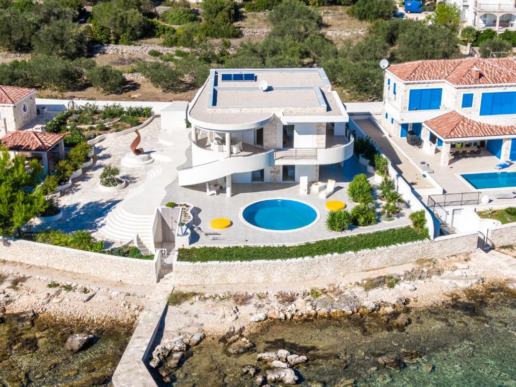 an aerial view of a house with a swimming pool at Villa Soleil in Vela Luka