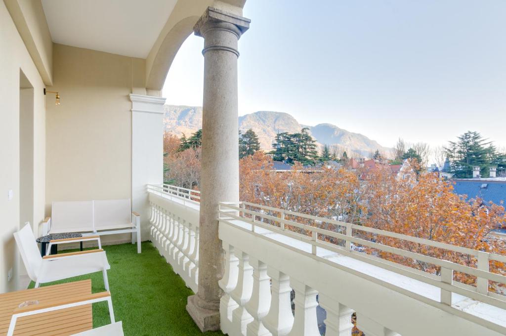 a balcony with a view of the water and mountains at Penthouse Jolanda Meran-o in Merano