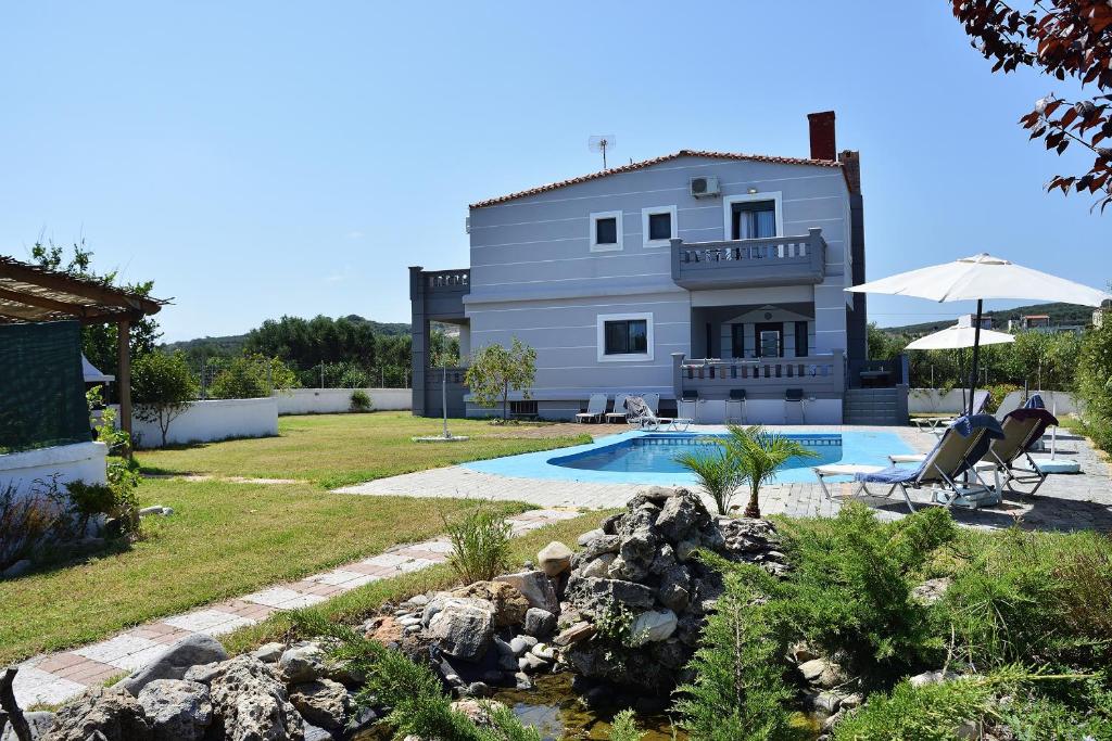 a villa with a swimming pool and a house at Villa Vassiliki in Kolymvari