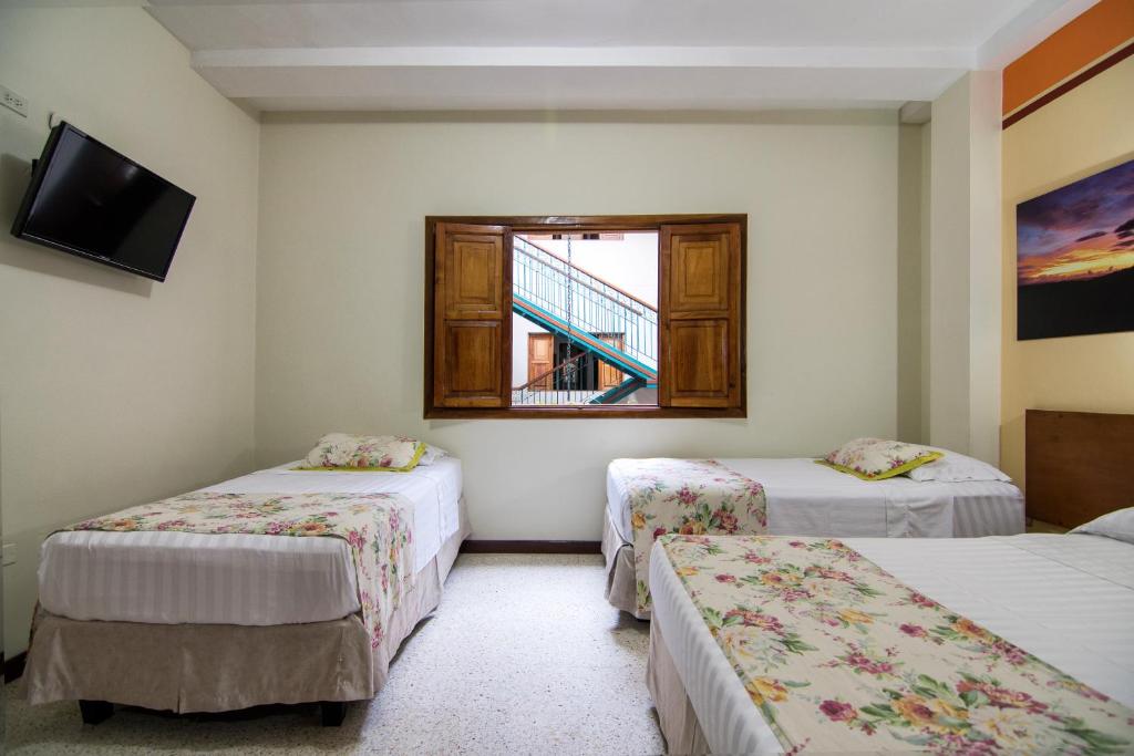 Postel nebo postele na pokoji v ubytování Hotel Valdivia Plaza