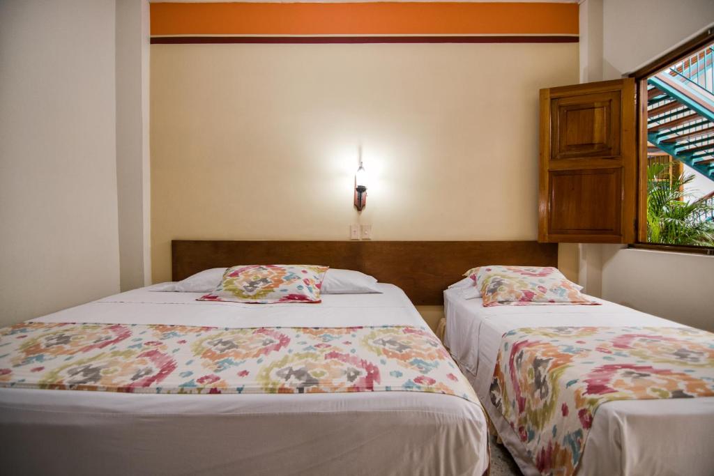 Postel nebo postele na pokoji v ubytování Hotel Valdivia Plaza