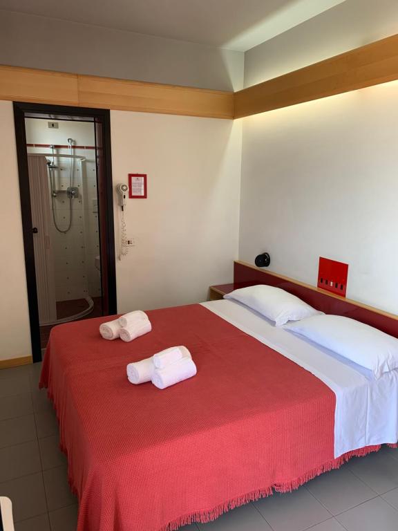 Postel nebo postele na pokoji v ubytování Hotel Giglio