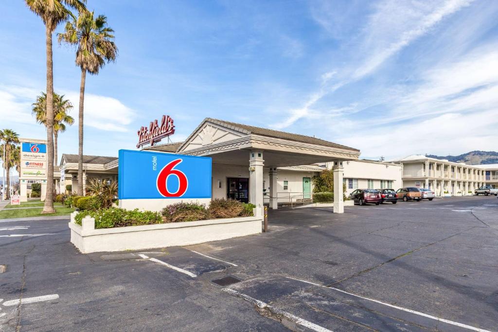 a store front with a sign in a parking lot at Motel 6 San Rafael in San Rafael