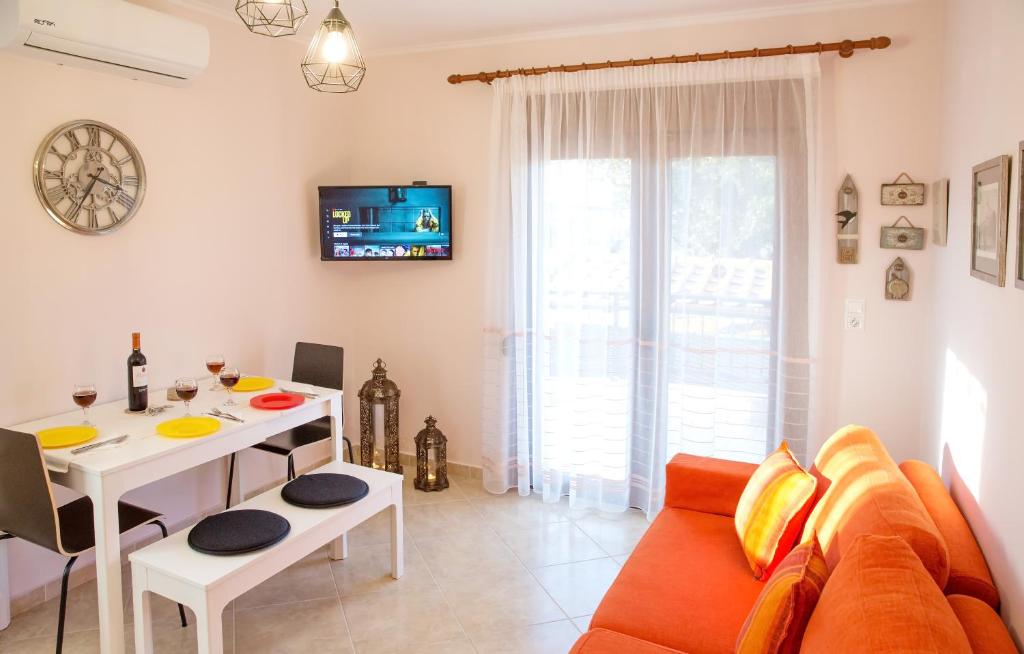 a living room with a couch and a table at Konstantina & Evgenia Deluxe Apartment in Nea Peramos