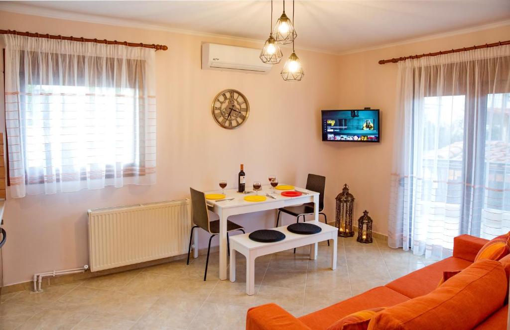 a living room with a table and a couch at Konstantina & Evgenia Deluxe Apartment in Nea Peramos