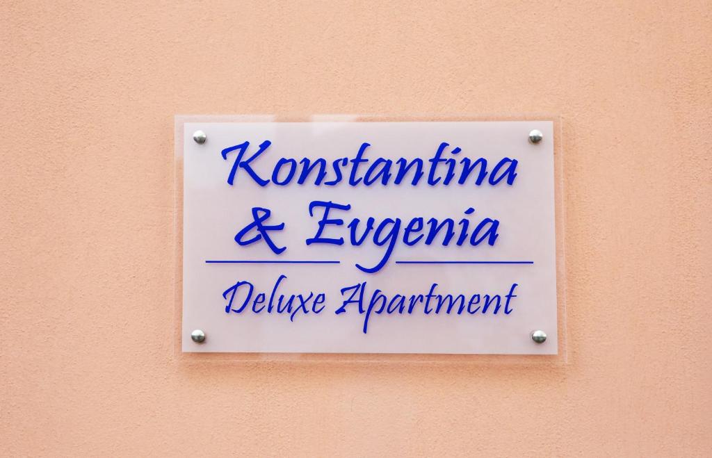 a sign on a wall that says kontitution and emperoruce attachment at Konstantina & Evgenia Deluxe Apartment in Nea Peramos