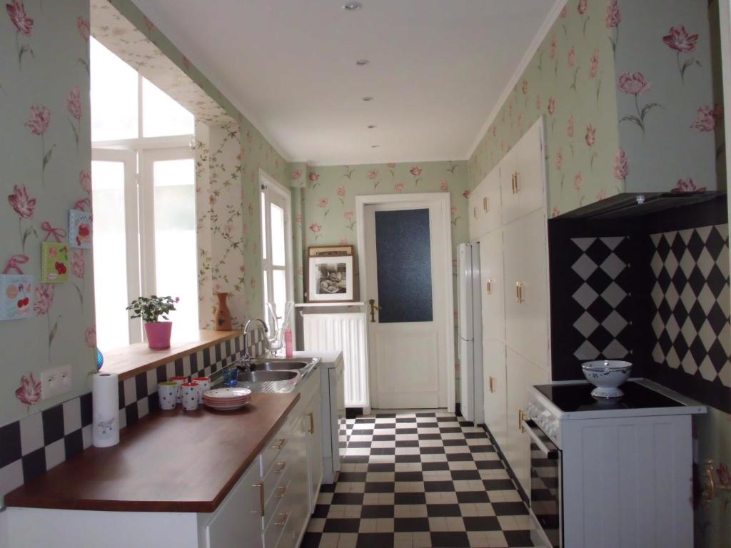 a kitchen with a checkered floor at Apartments Suites in Antwerp in Antwerp