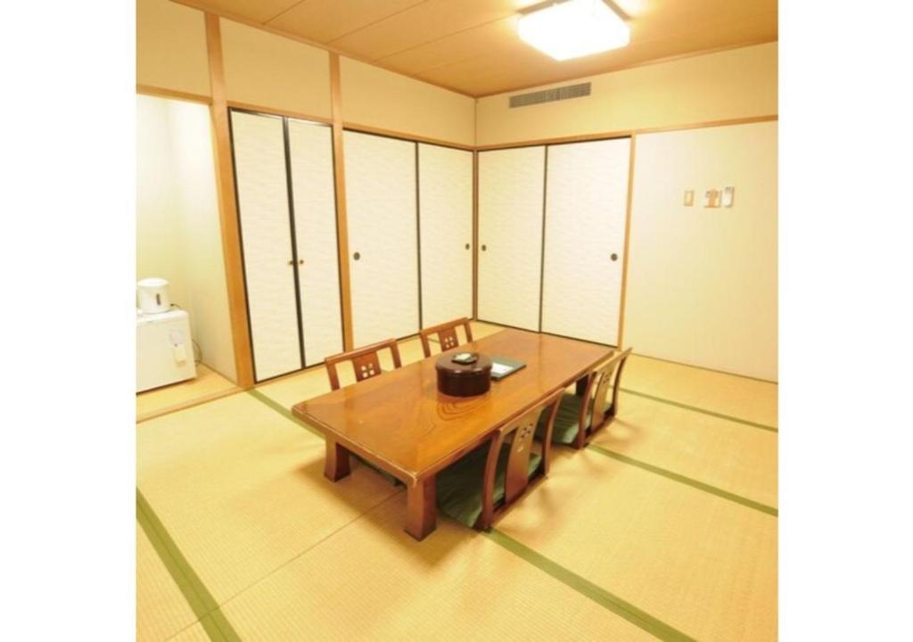 a room with a wooden table and chairs in it at Isawa no sato / Vacation STAY 61566 in Shiso